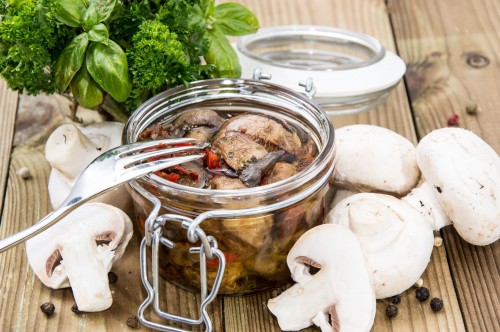 Marinated mushrooms in glass jar
